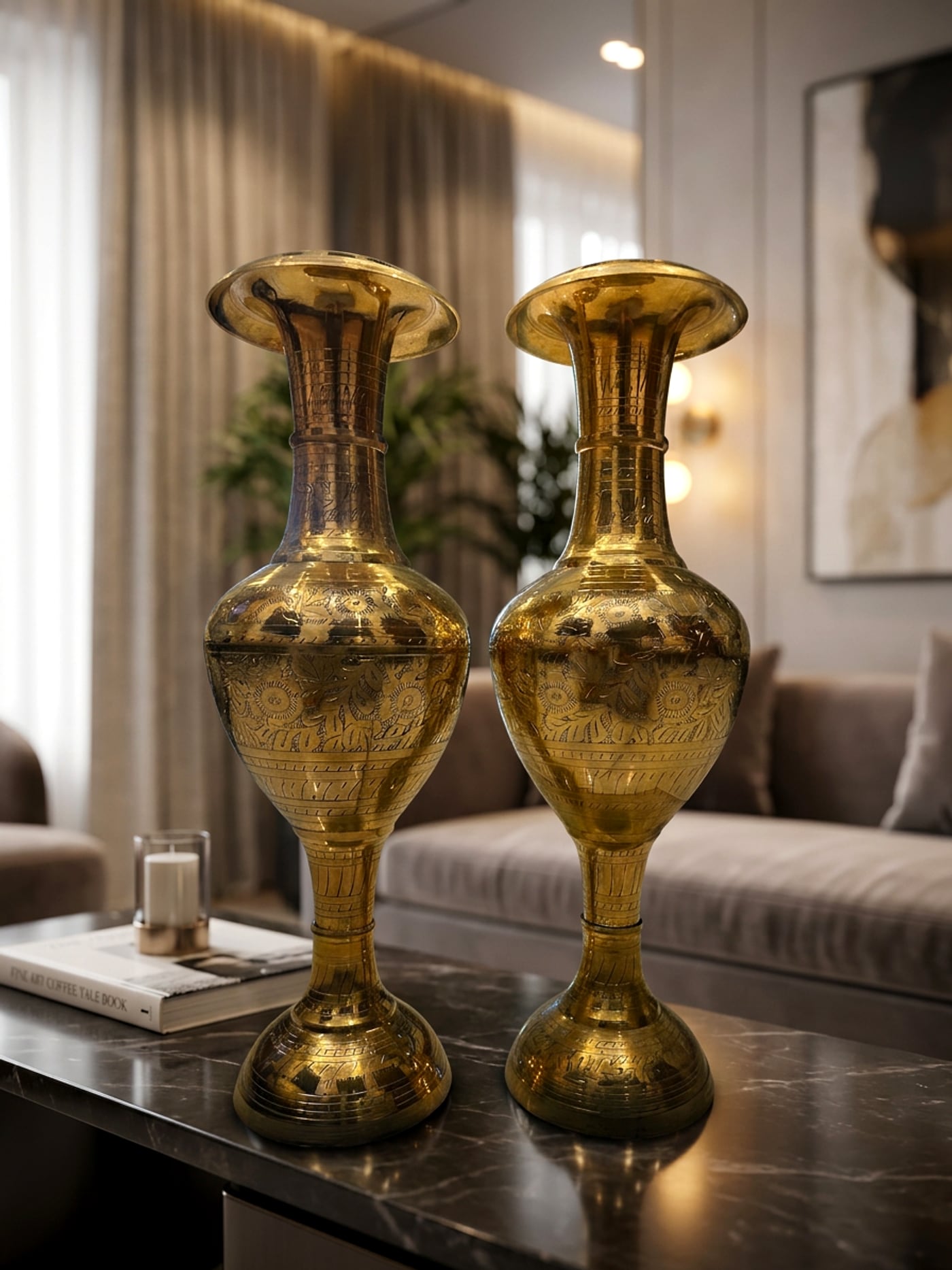A matched pair of hand-engraved brass floor vases styled on a marble table